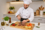 Chef preparing food on a Nolly Home premium bamboo cutting board in a kitchen